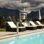 Dominator poolside basketball hoop beside a pool with lounge chairs